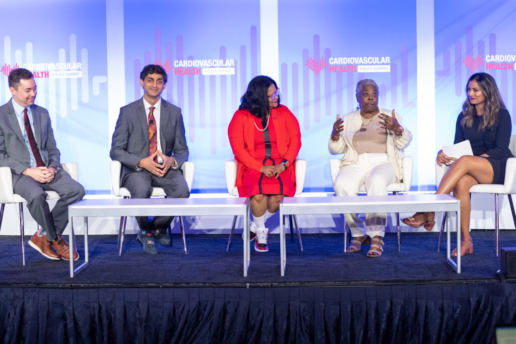 A panel of leaders speaking on stage having a conversation at the 2022 Cardiovascular Health Policy Summit